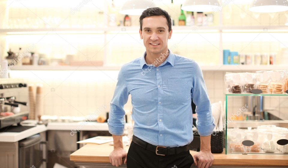 Young man standing in store. Small business owner portrait